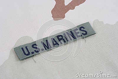 US MARINES branch tape with dog tags on desert camouflage uniform Stock Photo