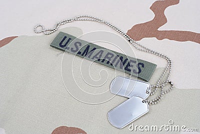 US MARINES branch tape with dog tags on desert camouflage uniform Editorial Stock Photo