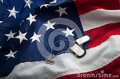 US Military dog Tags and the American Flag Stock Photo