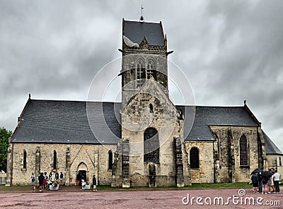 US Paratrooper dummy hanging from church tower to remember 82nd division airborne operations beginning of D-Day landings in Norman Editorial Stock Photo