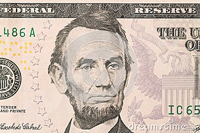 US President Abraham Abe Lincoln on USA five dollar bill macro, 5 usd Editorial Stock Photo