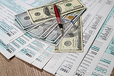 1040 us tax form. financial docs with dollar on desk Editorial Stock Photo