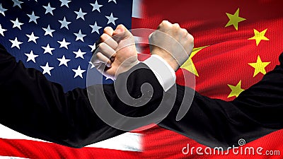 US vs China confrontation, countries disagreement, fists on flag background Stock Photo