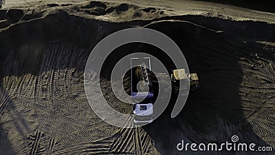 USA, California - May 20, 2022: excavator digging and loading sand into dump truck at river bank. Scene. Heavy machinery Editorial Stock Photo