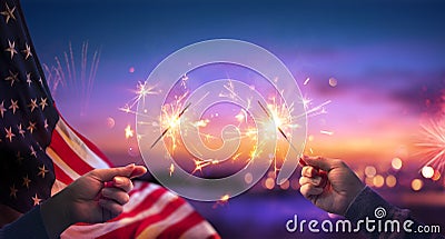 Usa Celebration With Hands Holding Sparklers And American Flag At Sunset Stock Photo