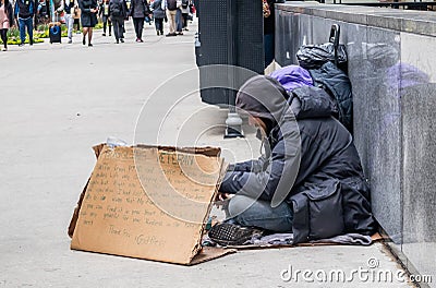 Homeless man with a cardboard sign, begging, downtown Editorial Stock Photo