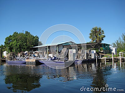 Airboats stationed at dock in Everglades city Florida Editorial Stock Photo