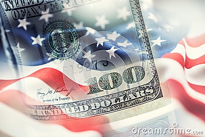 USA flag and American dollars. American flag blowing in the wind and 100 dollars banknotes in the background Stock Photo