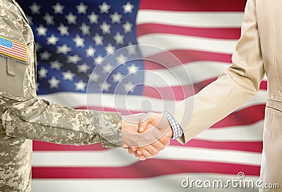 USA military man in uniform and civil man in suit shaking hands with national flag on background - United States Stock Photo