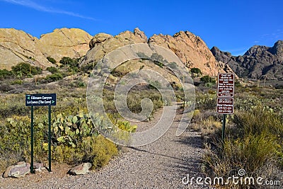 `Fillmore Canyon. La Cueva. The cave` sign on mountain landscape with prickly pear cacti, New Mexico Editorial Stock Photo