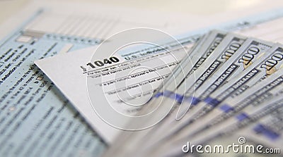 USA Tax Form 1040 with 100 US dollar bills Editorial Stock Photo