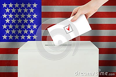 USA Vote concept. Voter hand holding ballot paper for election vote on polling station Stock Photo