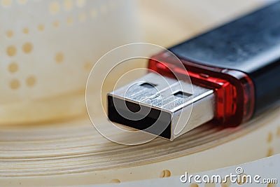 Usb flash drive and obsolete punched tape, archives Stock Photo