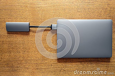 USB hub connected to laptop. Lack of hardware ports on modern laptops concept. Stock Photo