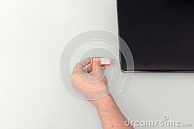 USB memory stick - Flash drive in hand by connecting it to a notebook computer Stock Photo