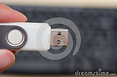 USB thumb drive with hand holding on keyboard background Stock Photo