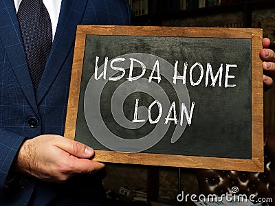 USDA HOME LOAN text in search bar. Businessman looking at cellphone Stock Photo