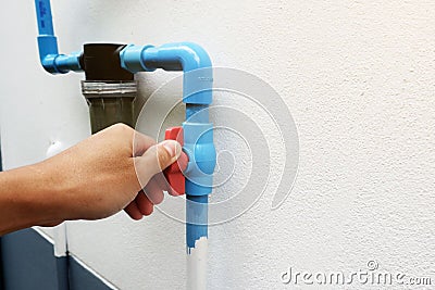 Use hand to twist the valve to open and close the water before entering the water filter Stock Photo