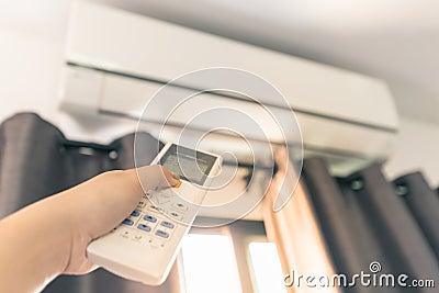 Use the Remote Control to Turn On the Air Conditioner Stock Photo