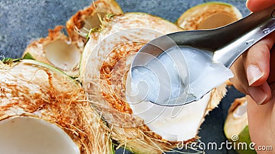 Use spoon picking up young green coconuts with nutrient, health Stock Photo