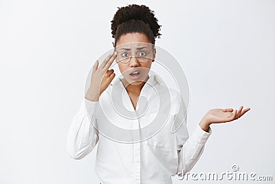 Use your brain, stupid. Annoyed and displeased good-looking african-american entrepreneur in glasses and white shirt Stock Photo