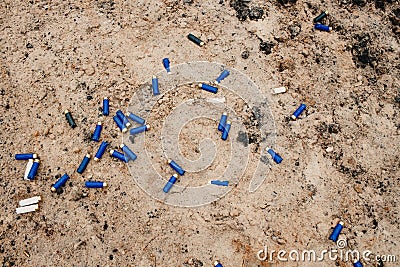 Used ammunition cartridges on a soil. 12 mm. background Stock Photo