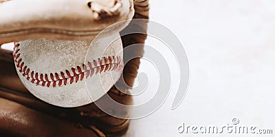 Used baseball in brown glove closeup Stock Photo