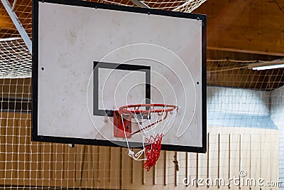 Used basketball backboard, hoop, net inside of basketball court, Left side view Stock Photo