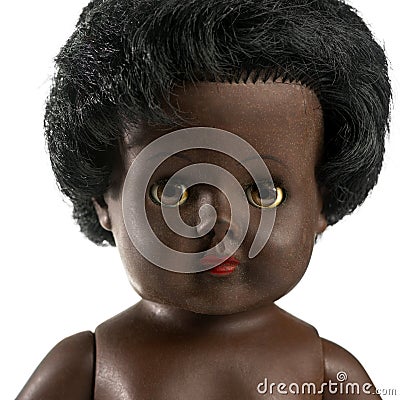 Used black doll in front of a white background Stock Photo