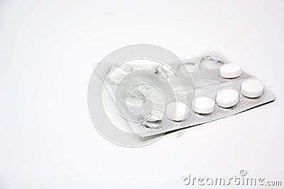 A used blister pack with some missing pills isolated on a white background Stock Photo