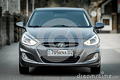 Used budget korean car b class in gray color, sedan front view Editorial Stock Photo