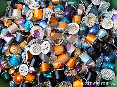 Used coffee capsules in many different colours in a disposal waste container Stock Photo
