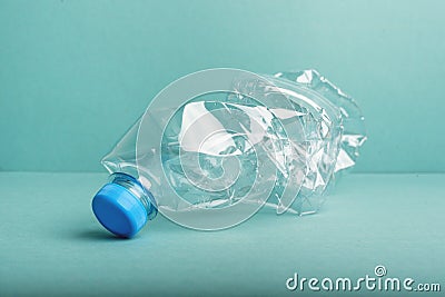 Used crushed plastic bottle on blue background Stock Photo