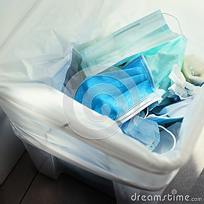 Used face masks in a contaminated waste bin Stock Photo