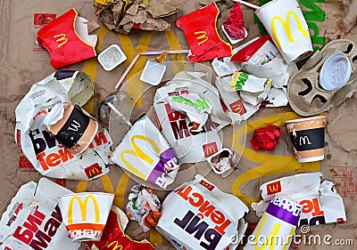 Used paper disposable packs McDonalds. Fast foodâ€™s litter legacy. Discarded paper coffee cup. Pile of abandoned garbage Editorial Stock Photo