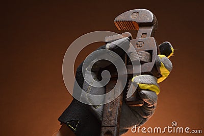 Pipe wrenches in hand of workman Stock Photo