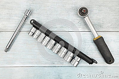 Used rachet tools above blue wooden planks background with copy space Stock Photo