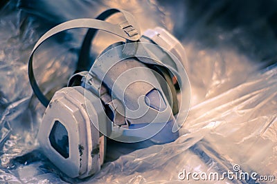 The used respirator lies on the cellophane Stock Photo