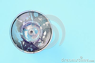 Used spray can with blue paint drips lie on texture background of fashion pastel blue color paper Stock Photo