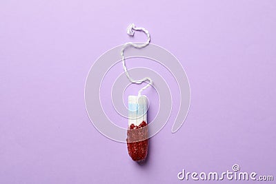 Used tampon on violet background Stock Photo