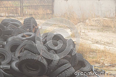 Used tires lie on the ground in a landfill in ukraine, an environmental problem of the industry Stock Photo