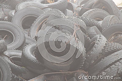 Used tires lie on the ground in a landfill in ukraine, an environmental problem of the industry Stock Photo