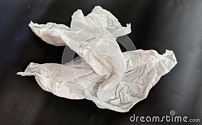 used tissue carelessly discarded with black background Stock Photo