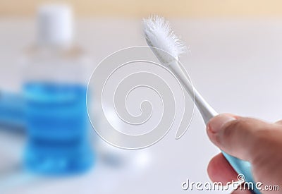 Used toothbrush in hand of man. Stock Photo