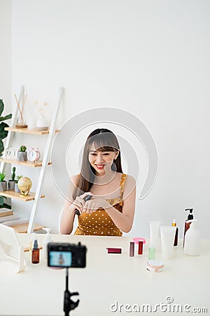 Useful beauty blog. Nice attractive woman giving advice about cosmetics while having her beauty blog Stock Photo