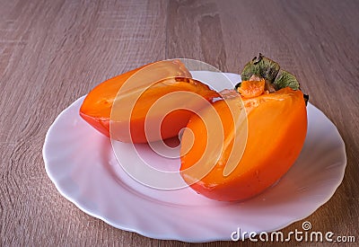 Persimmon fruit, close ripe fruits on a plate Stock Photo