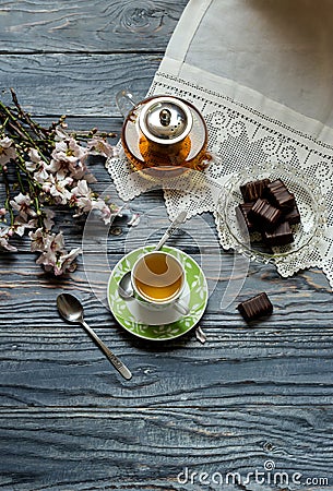 Useful, hot herbal tea, candy and flowering almond twigs Stock Photo