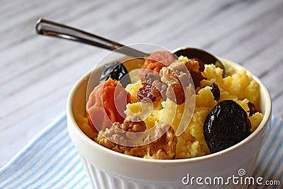 Useful porridge of corn grits and dried fruits. Stock Photo