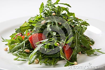 Useful strawberry salad with arugula nuts and honey on the white plate Stock Photo