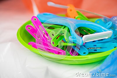 Useful tool made of harmful plastic being in pile with cheap pins Stock Photo
